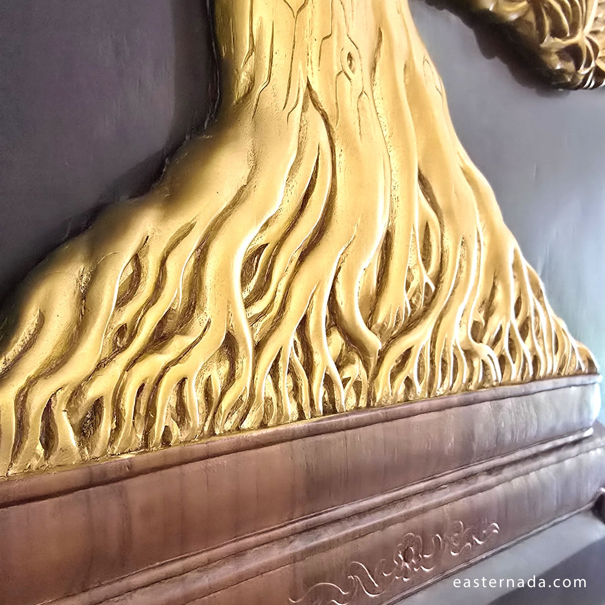 Close-up of hand-painted gold calligraphy-style branches on a 3D teakwood carving; showcasing high-relief artisan detail
