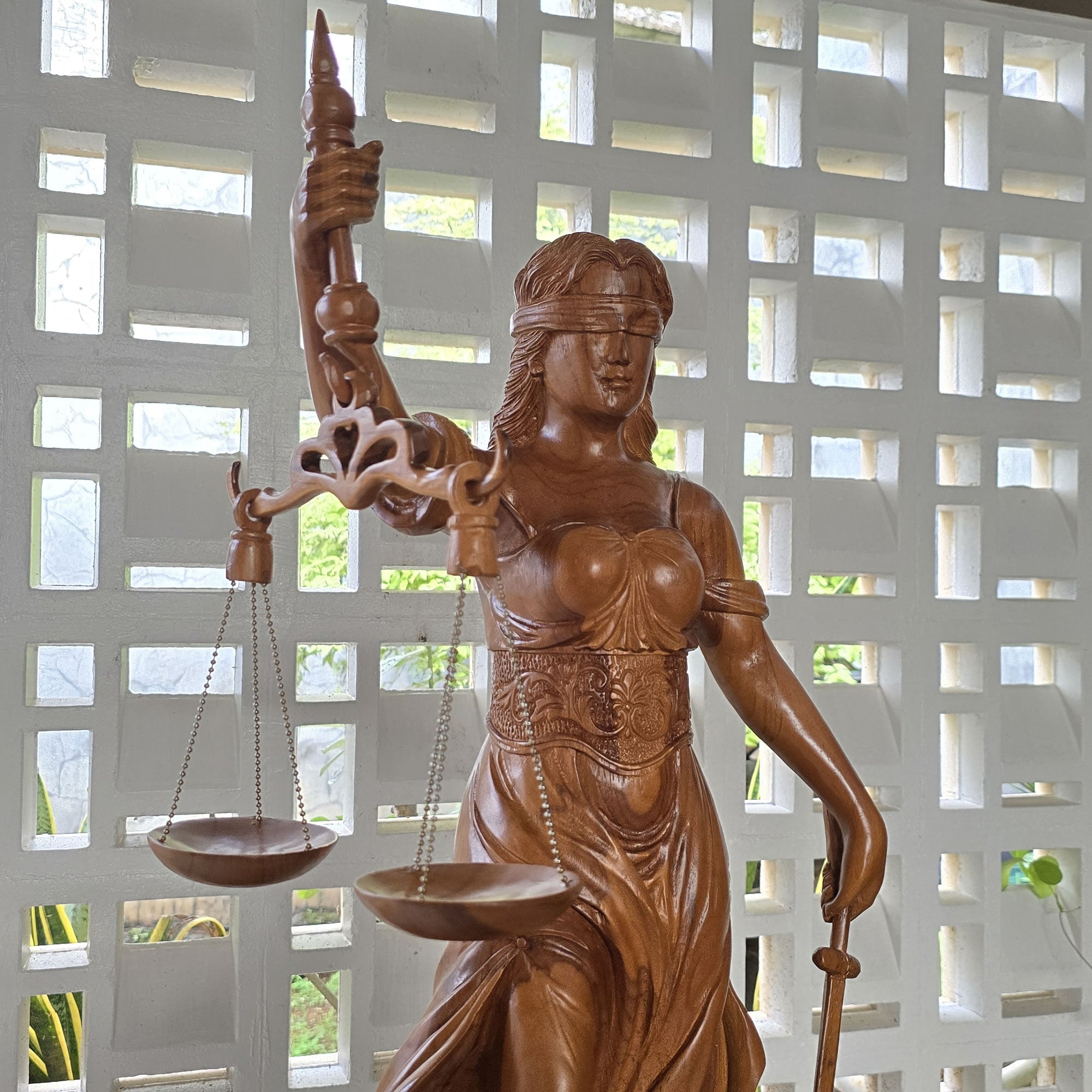 Hand-carved out of solid teakwood, this Lady Justice Greek Goddess sculpture is unique and rare.