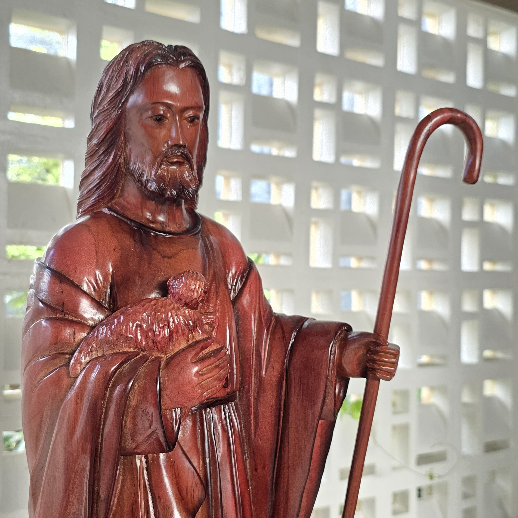 Wooden statue of Jesus the shepherd holding a lamb, a decorative teakwood sculpture unique and rare