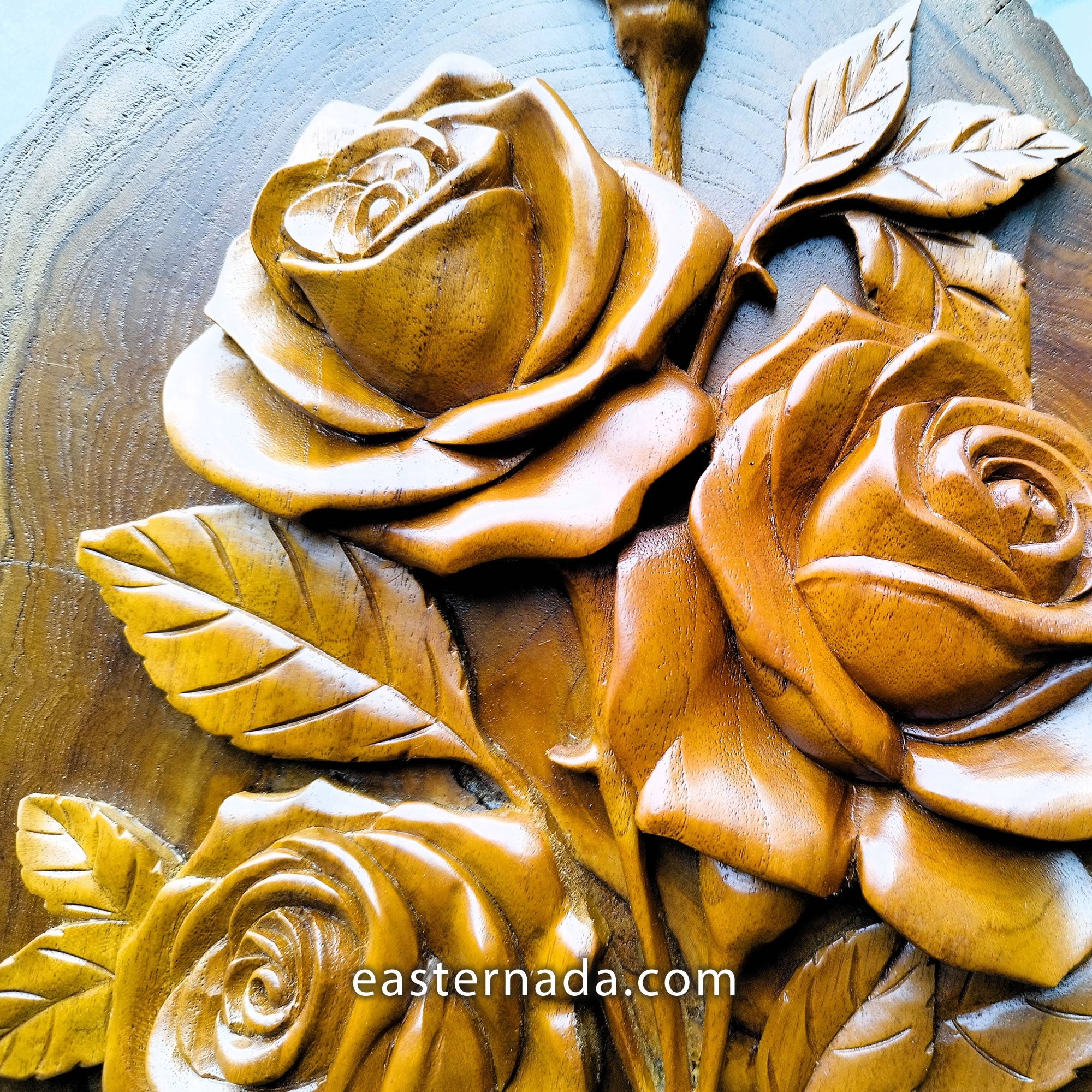 close-up of hand-carved teakwood roses sculpture highlighting the 3D relief carving and the thickness of the solid wood on a gallery wall