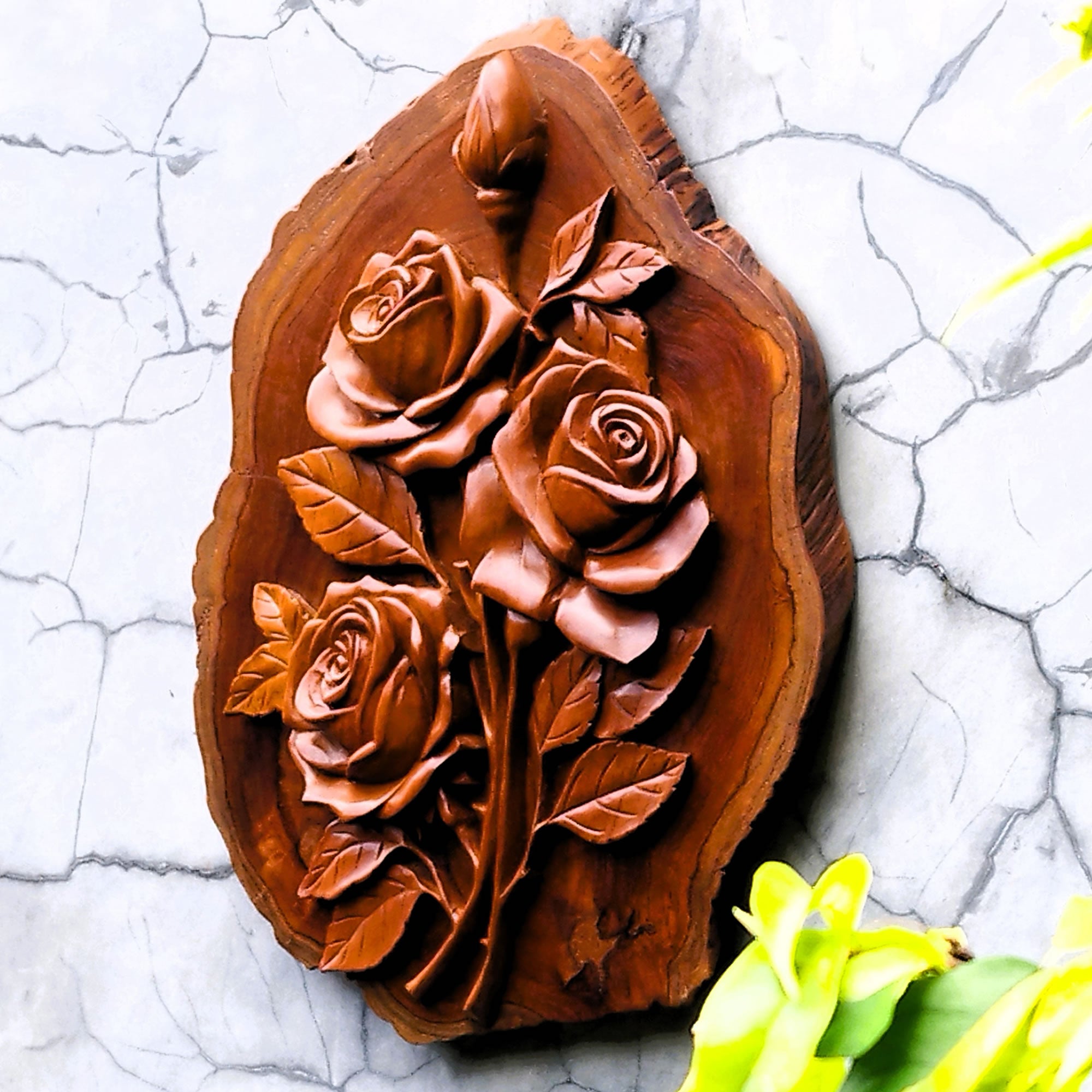 Side view of hand-carved teakwood roses sculpture highlighting the 3D relief carving and the thickness of the solid wood on a gallery wall