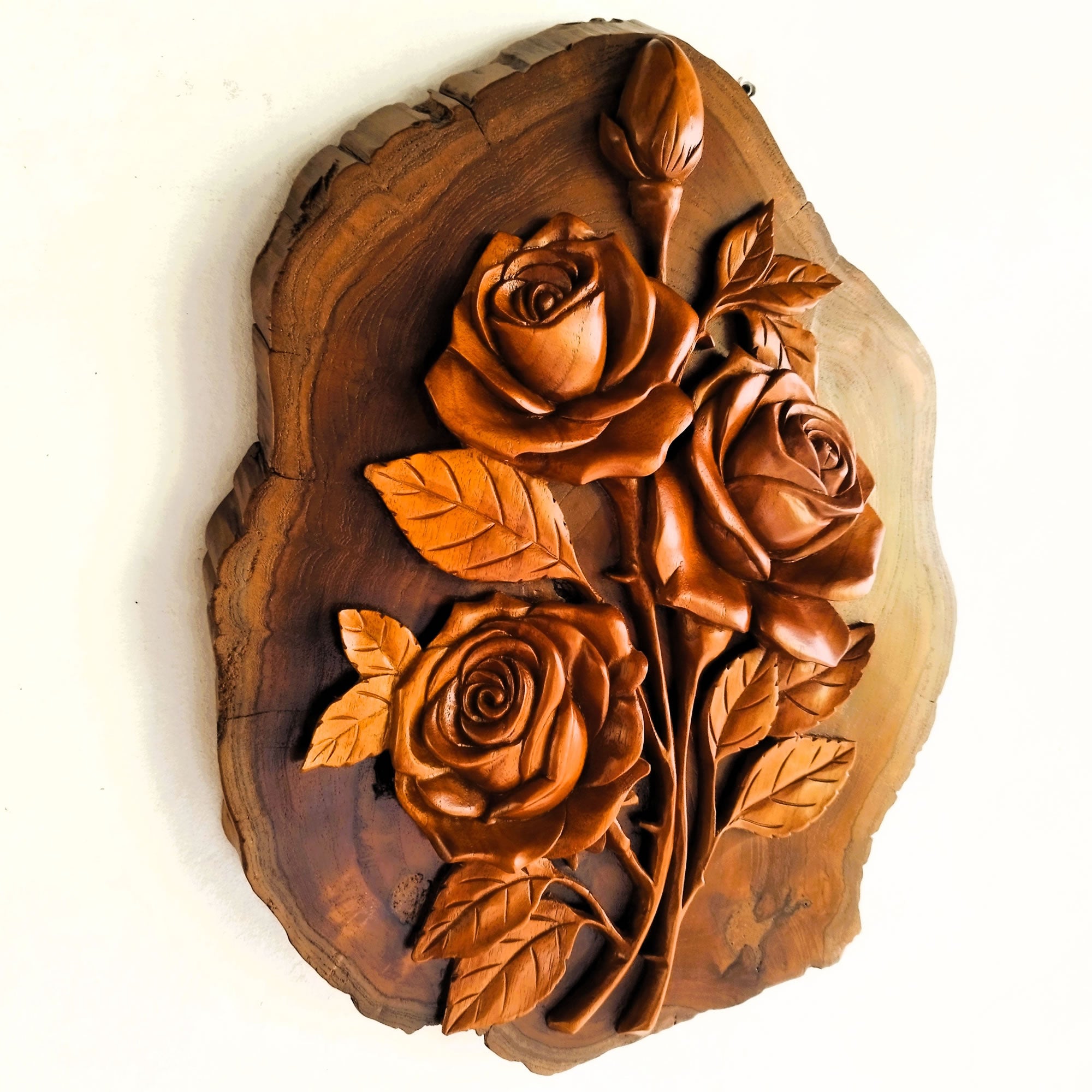 Front view of a hand-carved solid teakwood rose bouquet wall art, showing intricate floral detailing and the natural wood grain of the 40cm sculpture