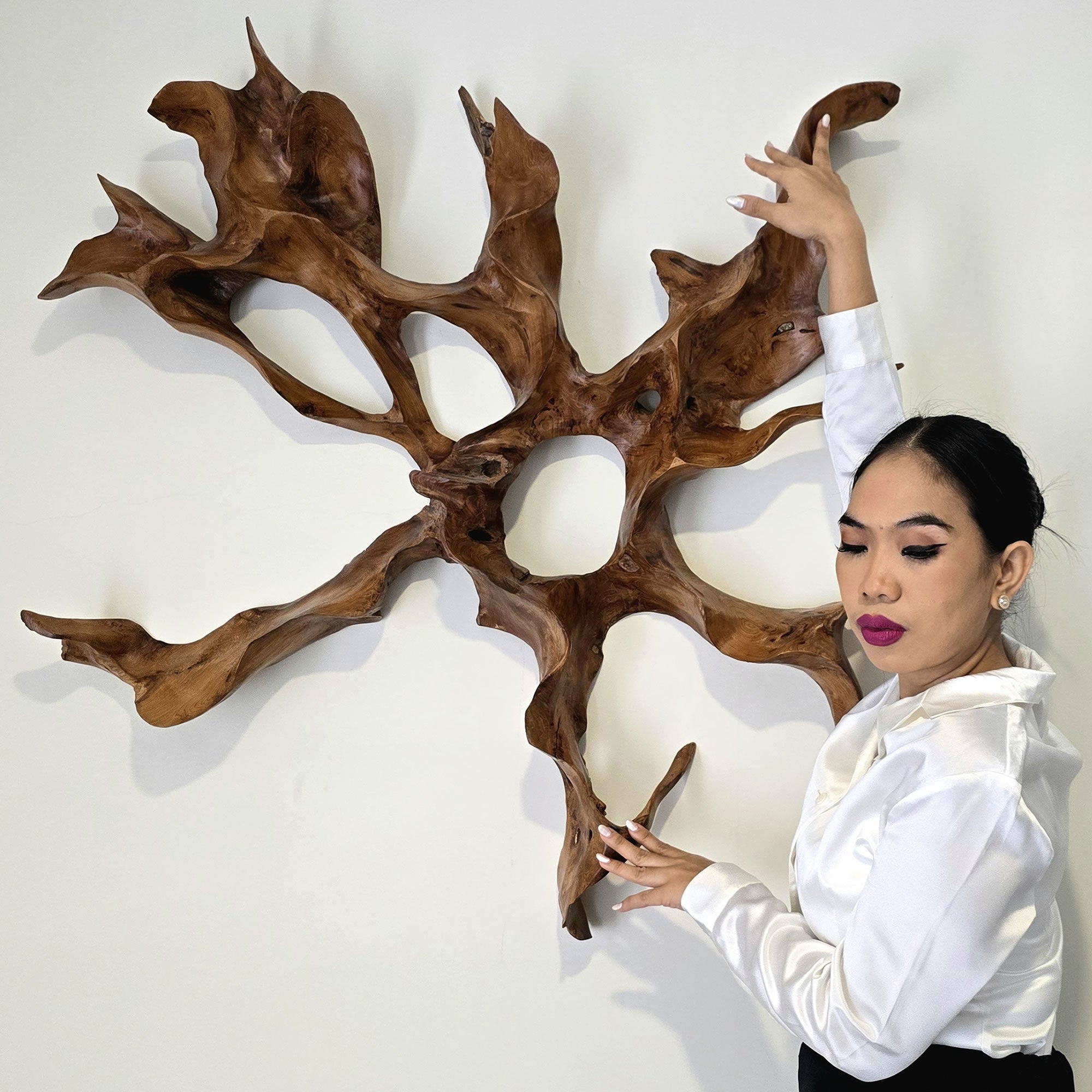 A unique teakwood root sculpture that serves as stunning wall art. This one-of-a-kind masterpiece will be the focal point in any room.