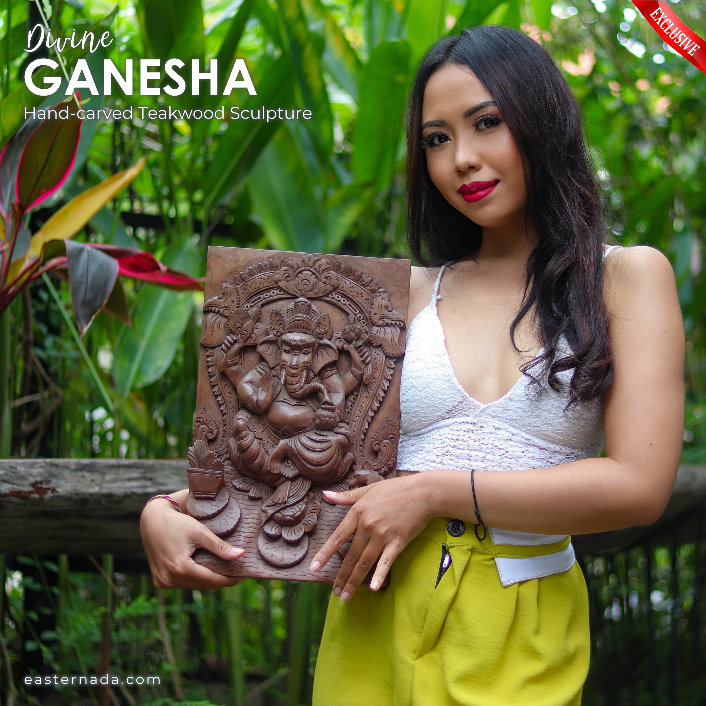 This is a stunning hand-carved teakwood Ganesha Ganapati Hindu God statue that depicts Divine Ganesha in all his glory. The intricate carving and attention to detail make this statue a true work of art.