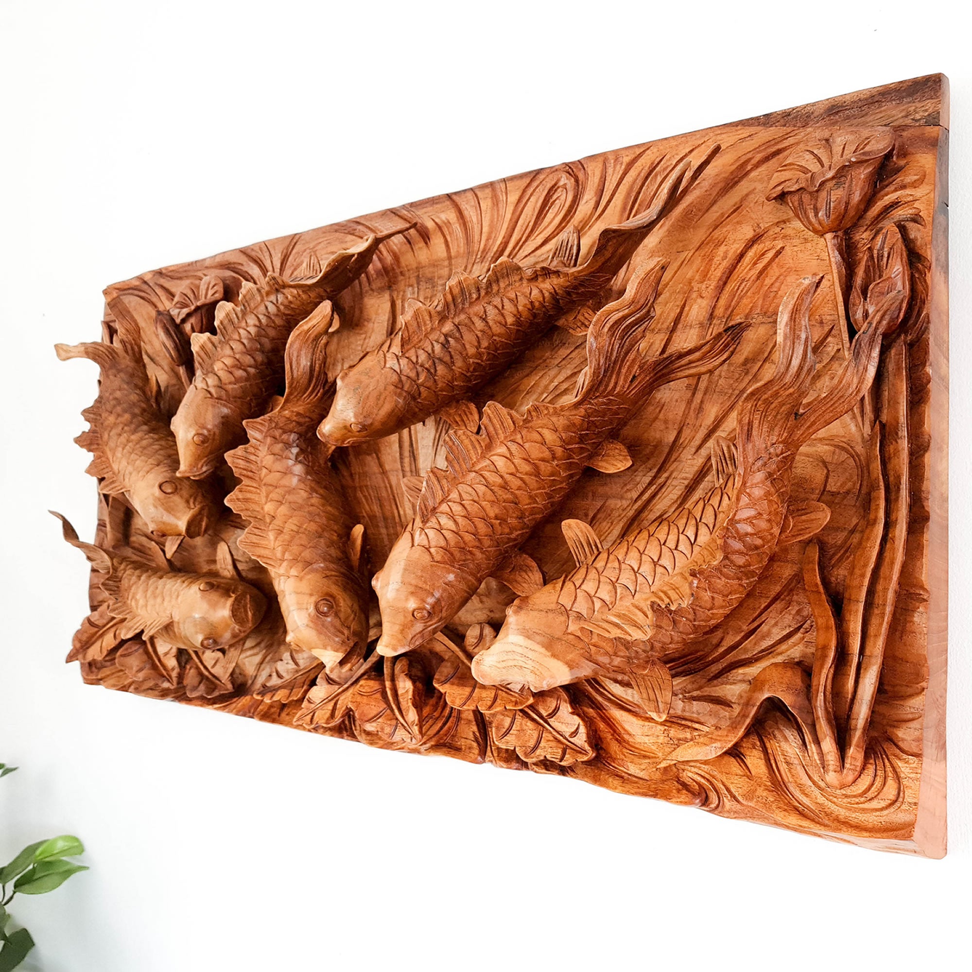Koi fishes hand carved out of a single piece of Teak wood. Koi fishes represent good luck, prosperity and abundance in Feng Shui. This is a stunning Carved Wooden Wall Art handmade with some eye catching results. An exclusive and unique piece, only one carved and available. A perfect gift.