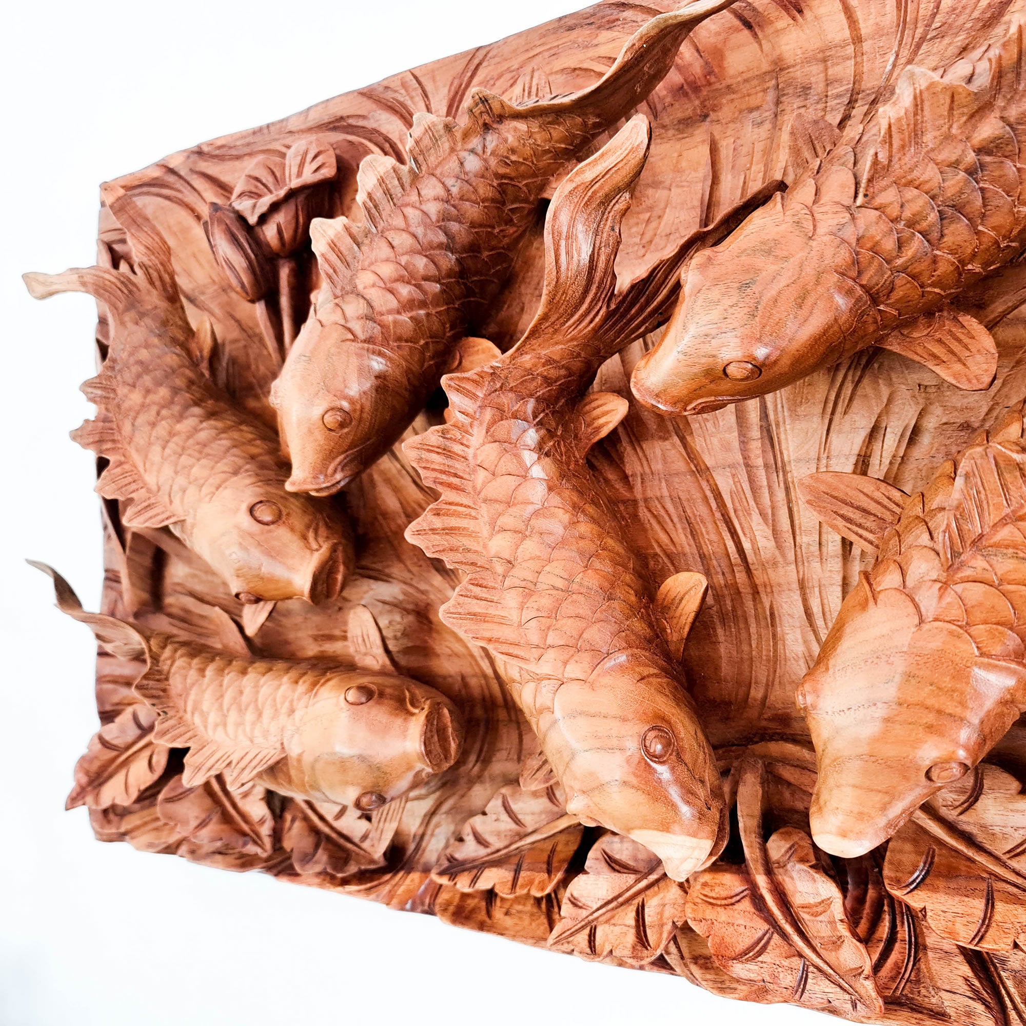 Koi fishes hand carved out of a single piece of Teak wood. Koi fishes represent good luck, prosperity and abundance in Feng Shui. This is a stunning Carved Wooden Wall Art handmade with some eye catching results. An exclusive and unique piece, only one carved and available. A perfect gift.