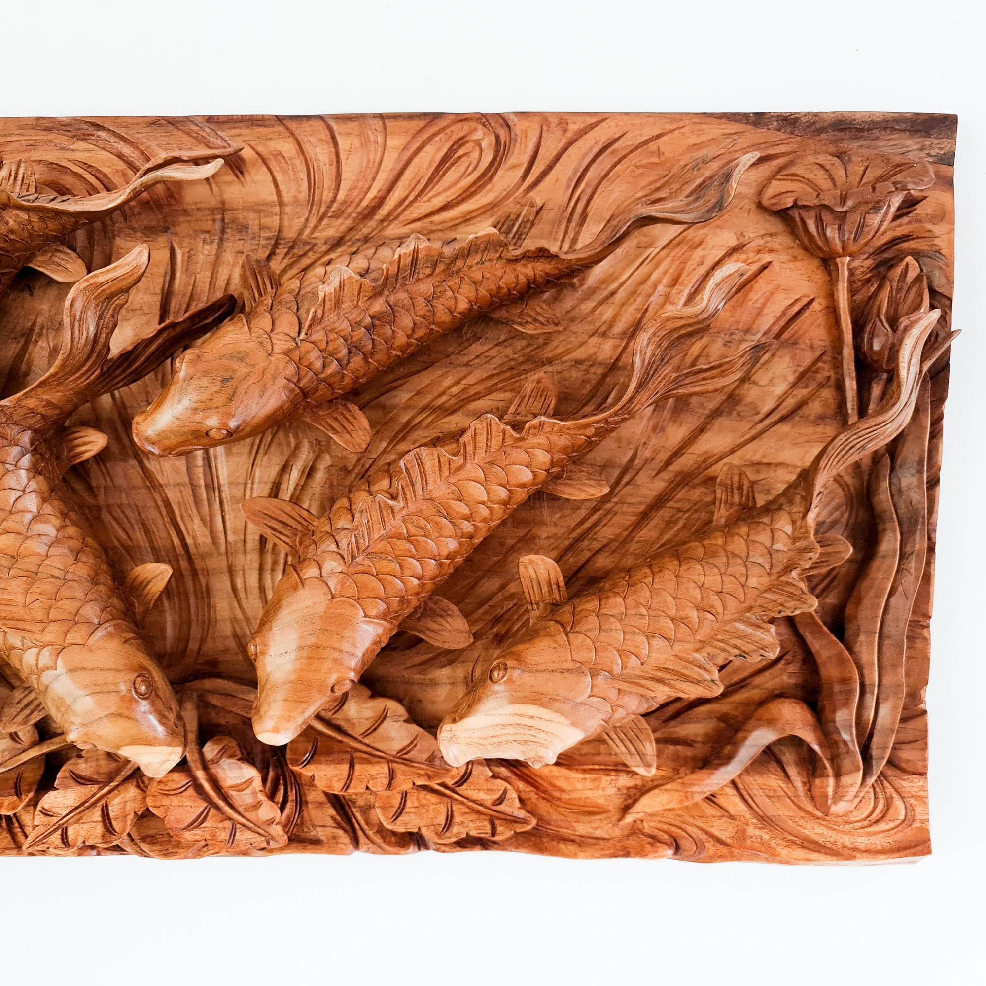 Koi fishes hand carved out of a single piece of Teak wood. Koi fishes represent good luck, prosperity and abundance in Feng Shui. This is a stunning Carved Wooden Wall Art handmade with some eye catching results. An exclusive and unique piece, only one carved and available. A perfect gift.