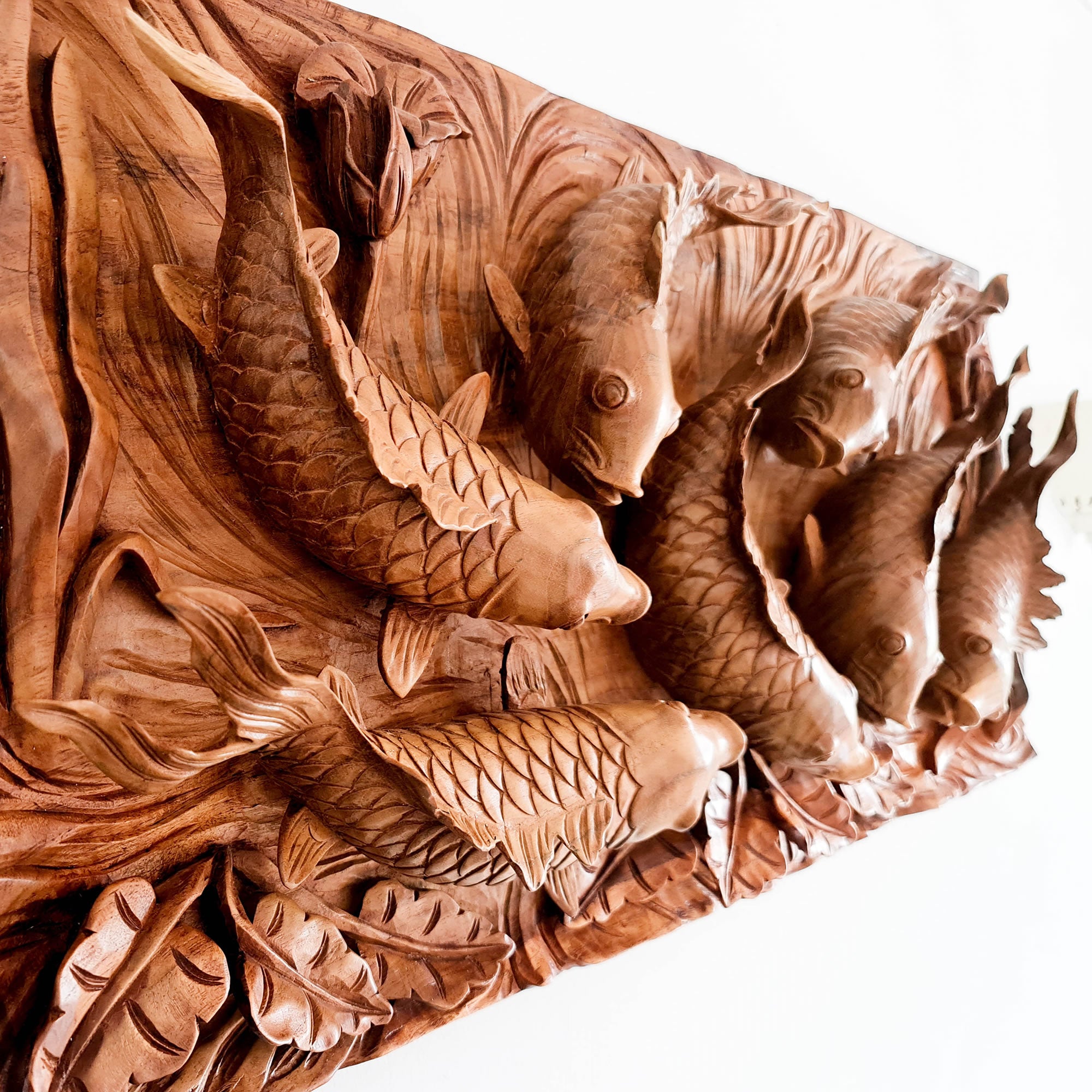 Koi fishes hand carved out of a single piece of Teak wood. Koi fishes represent good luck, prosperity and abundance in Feng Shui. This is a stunning Carved Wooden Wall Art handmade with some eye catching results. An exclusive and unique piece, only one carved and available. A perfect gift.