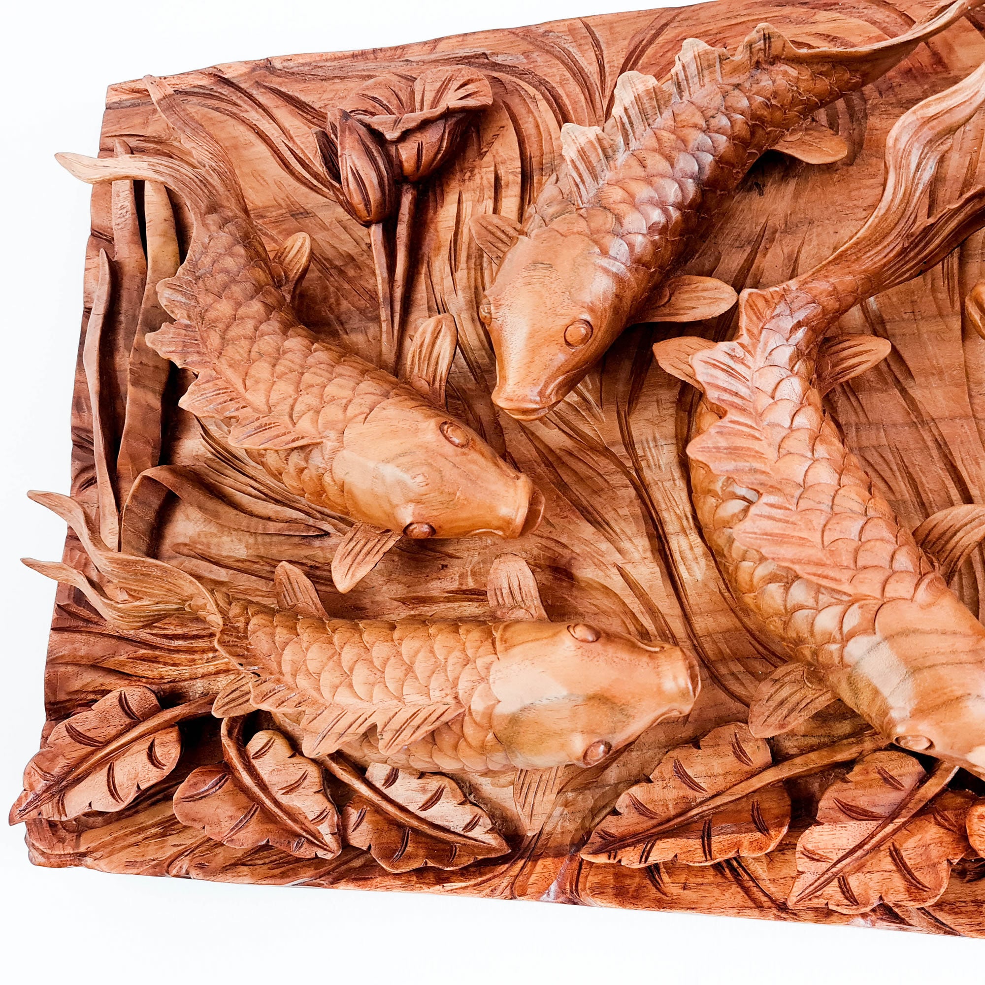 Koi fishes hand carved out of a single piece of Teak wood. Koi fishes represent good luck, prosperity and abundance in Feng Shui. This is a stunning Carved Wooden Wall Art handmade with some eye catching results. An exclusive and unique piece, only one carved and available. A perfect gift.