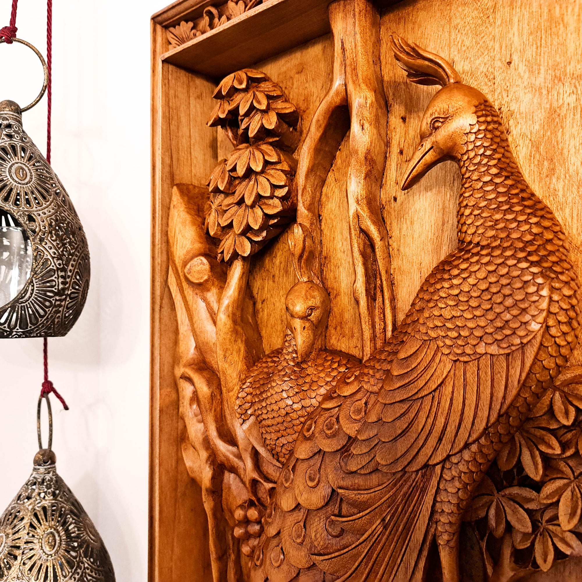 The Royal Peacock: Intricate 3D teakwood relief carving in a solid timber frame; artisanal hand-carved wall art for luxury home decor