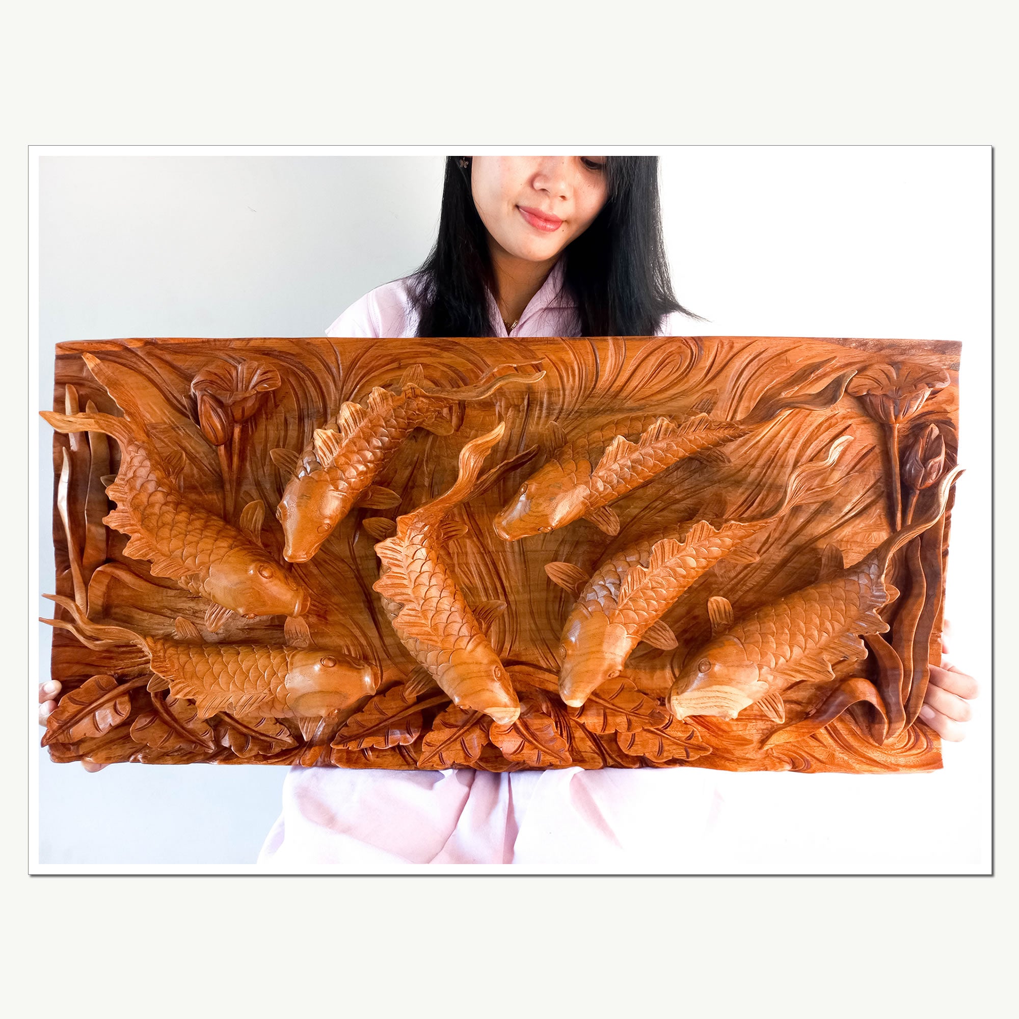 Koi fishes hand carved out of a single piece of Teak wood. Koi fishes represent good luck, prosperity and abundance in Feng Shui. This is a stunning Carved Wooden Wall Art handmade with some eye catching results. An exclusive and unique piece, only one carved and available. A perfect gift.