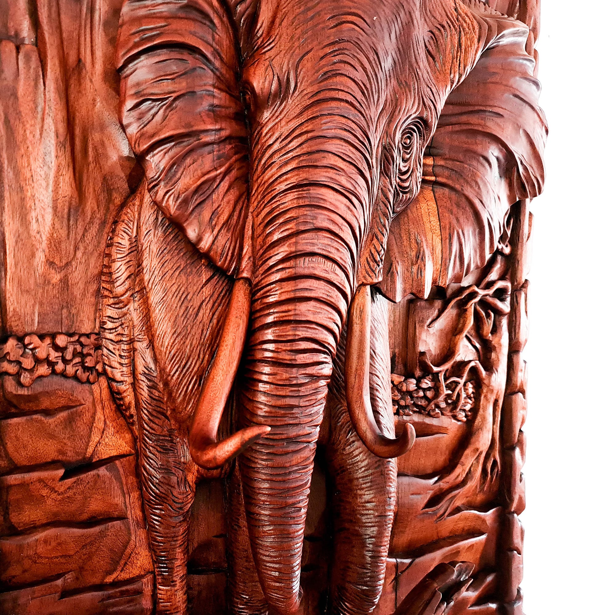This stunning hand-carved African elephant is undoubtedly a masterpiece. Carved out of solid teakwood, the carver has captured the raw majestic nature of the African elephant in its environment. A wood art that will adorn the walls and become a focal point in any room.