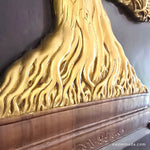 Close-up of hand-painted gold calligraphy-style branches on a 3D teakwood carving; showcasing high-relief artisan detail
