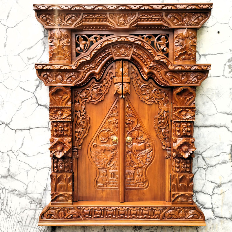 Frontal view of a hand-carved solid teakwood Gebyok wall art with doors closed, showing intricate Javanese floral carvings