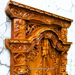 Close-up detail of the traditional Javanese carvings on the miniature Gebyok doors, showcasing the fine artisan craftsmanship