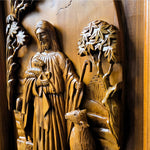 Detailed closeup of solid teak wood carving showing dimensional relief details of Jesus Christ as the sacred shepherd, hand-crafted wall sculpture.