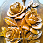 close up of hand-carved teakwood roses sculpture highlighting the 3D relief carving and the thickness of the solid wood on a gallery wall
