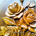 close-up of hand-carved teakwood roses sculpture highlighting the 3D relief carving and the thickness of the solid wood on a gallery wall