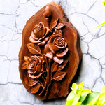 Side view of hand-carved teakwood roses sculpture highlighting the 3D relief carving and the thickness of the solid wood on a gallery wall