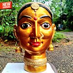 Hand-carved solid teakwood ethnic woman face sculpture with gold finish and silver jewelry embellishments.