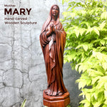 Hand-carved out of solid hardwood this sculpture is quite unique and rare. The image depicts the Virgin Mary with beautiful detail. A stunning Masterpiece. Bring home the blessings of Jesus and Mary. Easternada