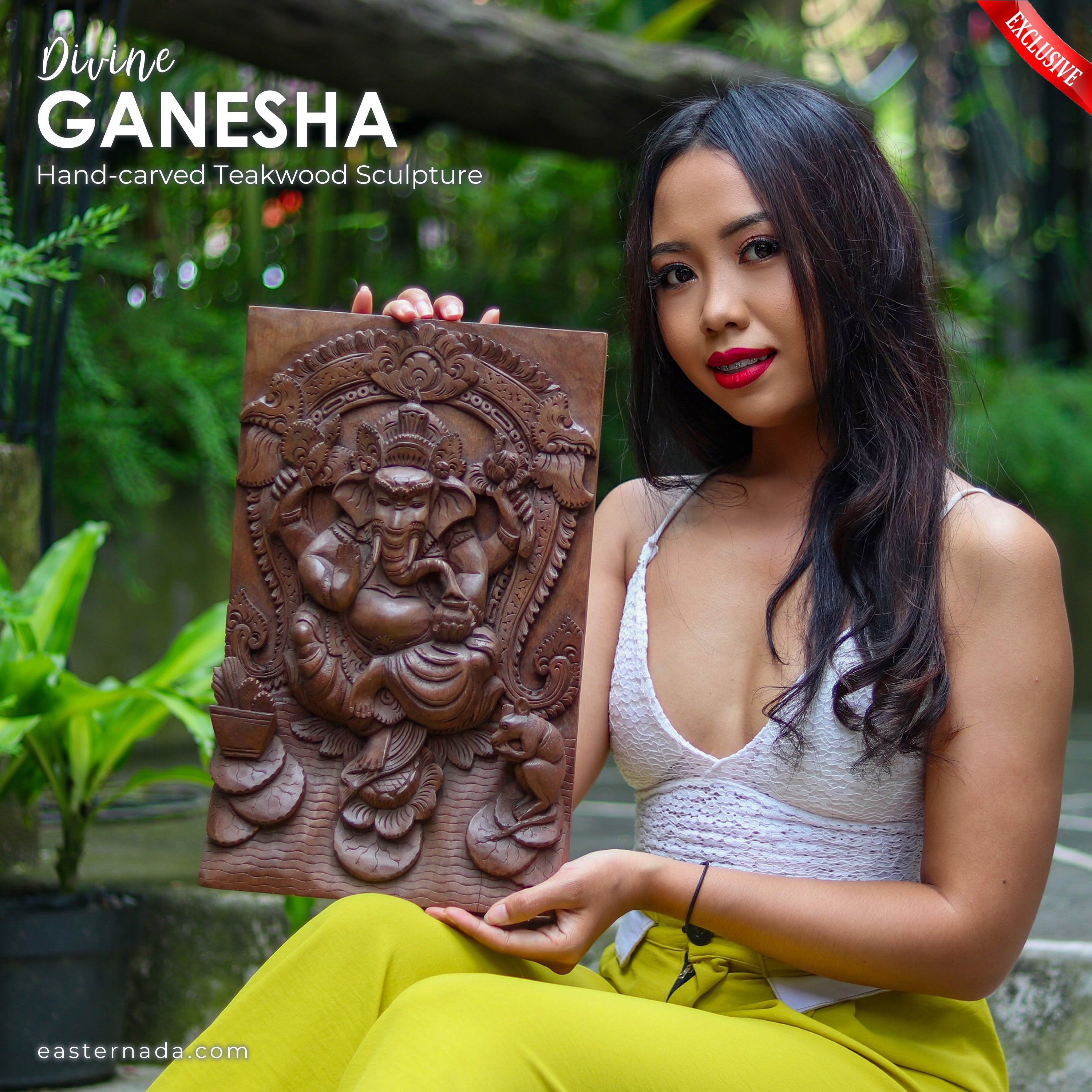 This is a stunning hand-carved teakwood Ganesha Ganapati Hindu God statue that depicts Divine Ganesha in all his glory. The intricate carving and attention to detail make this statue a true work of art.